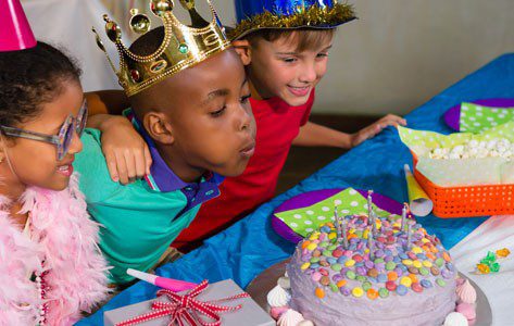 kids blowing candles