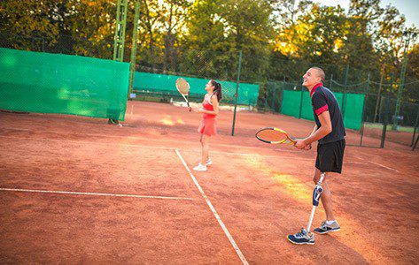 Man and woman playing tennis.