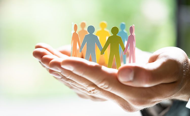 Hands holding a paper colorful cutout 