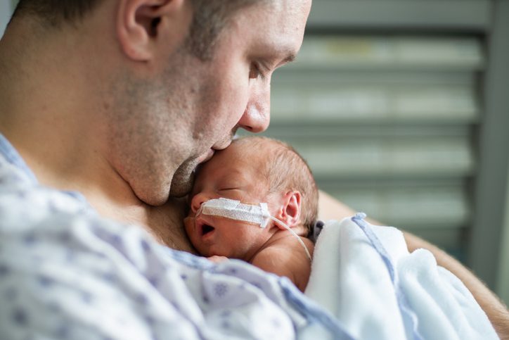 Father taking care of his premature baby  doing skin to skin at hospital. Color and horizontal photo was taken in Quebec Canada.