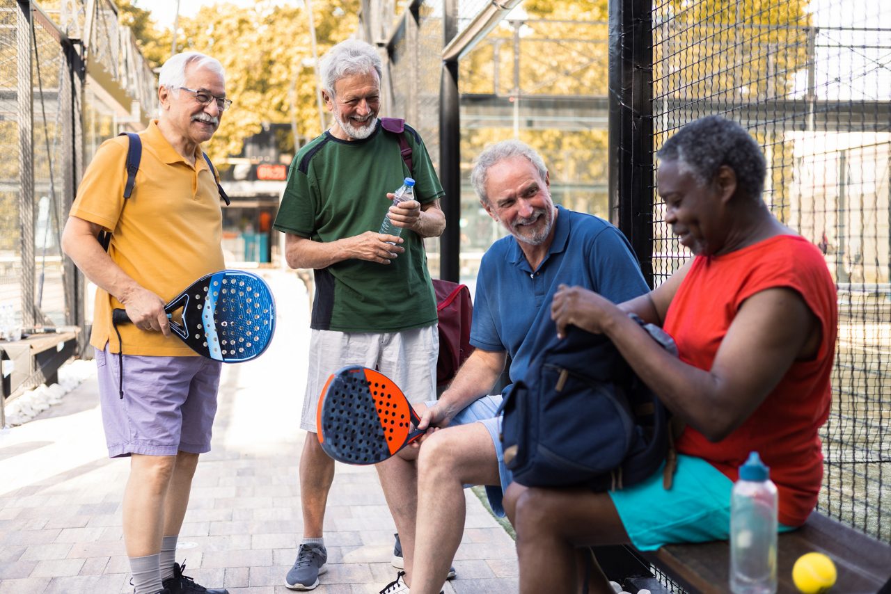 Four senior men meeting for a padel match in doubles