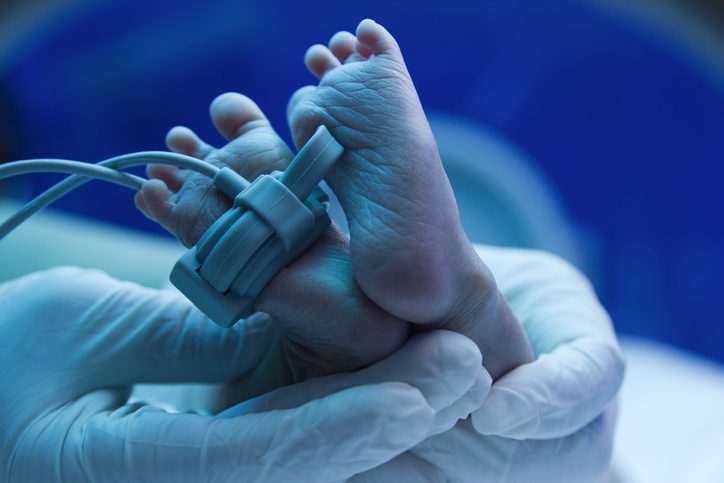 Doctor's hand care for a sick new born  in the pediatric ICU