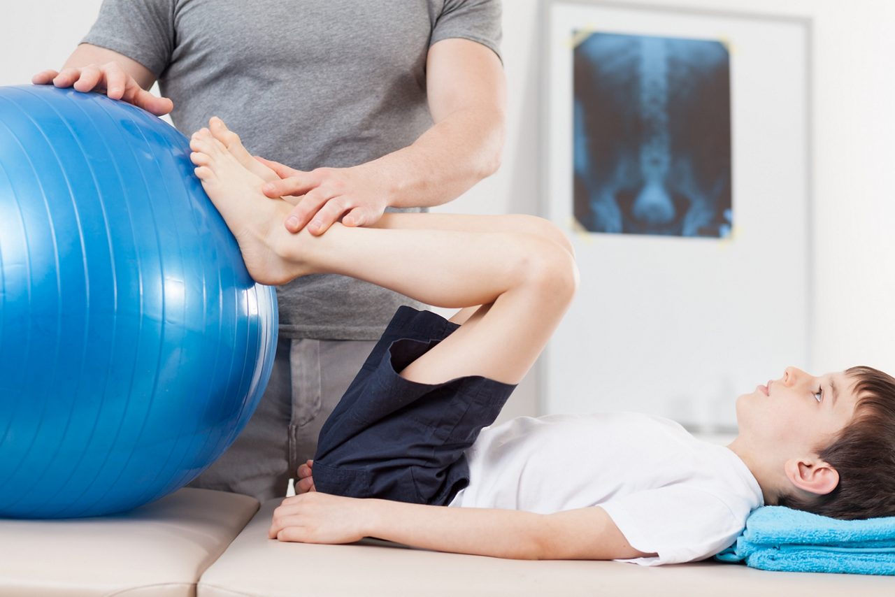 Picture of small patient doing exercises with fitness ball