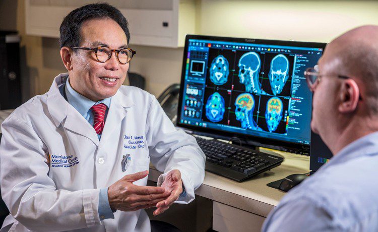 Doctor with patient looking at CT scans