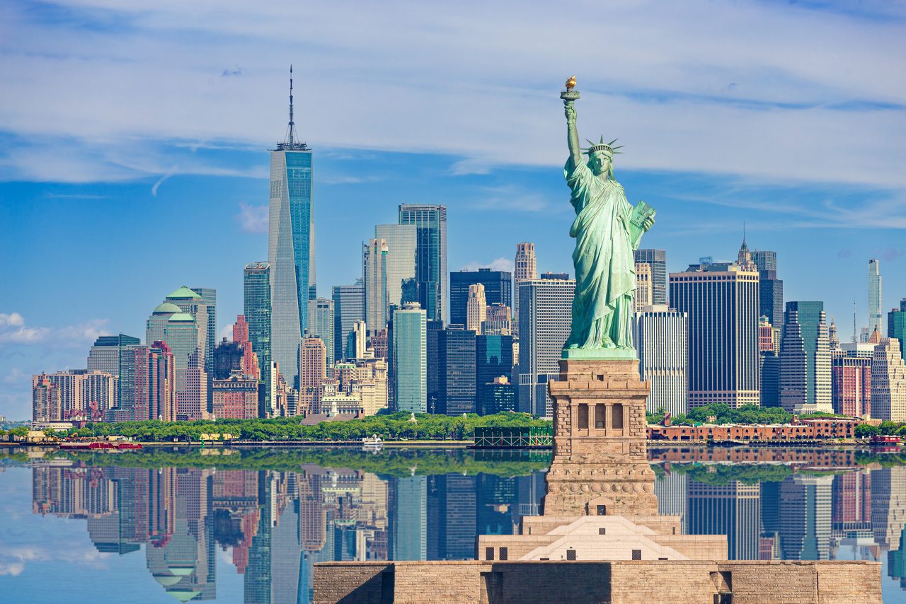 The Statue of Liberty with the New York City skyline in the background.
