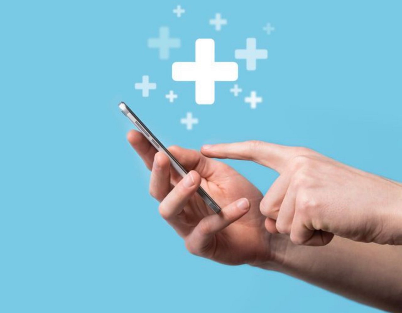 Hands typing on mobile phone