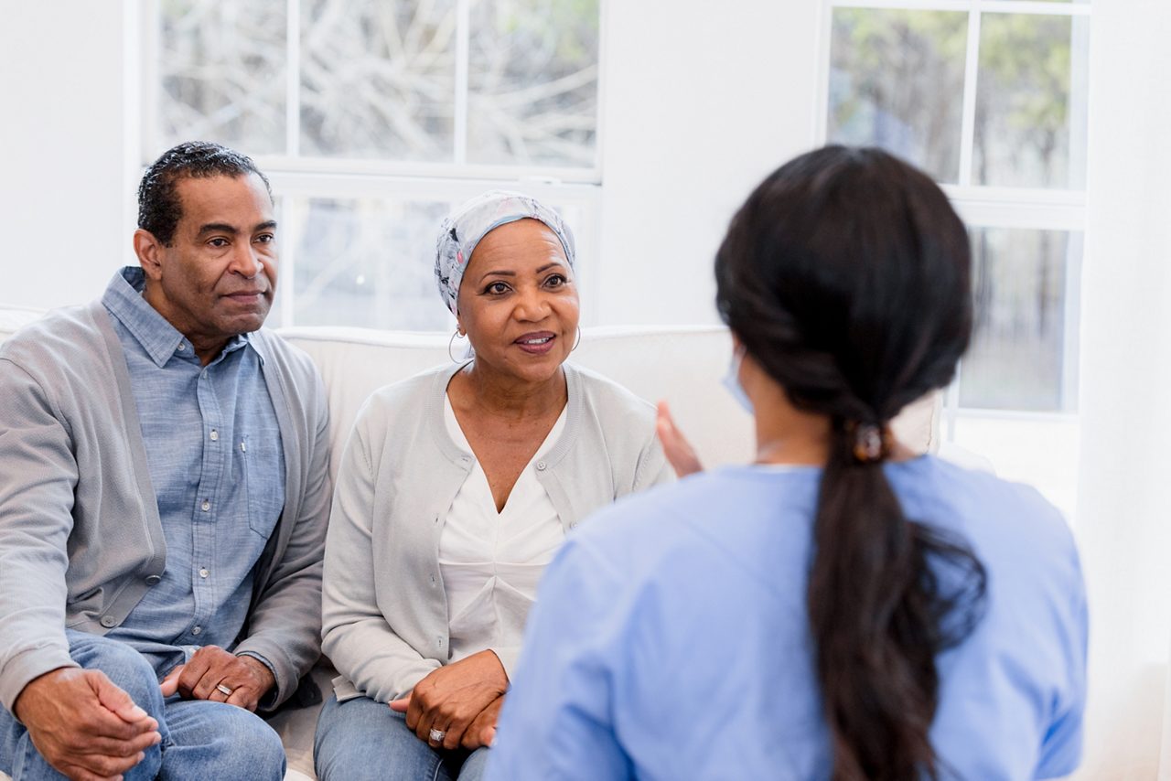 A couples sitting through a cancer counseling service.