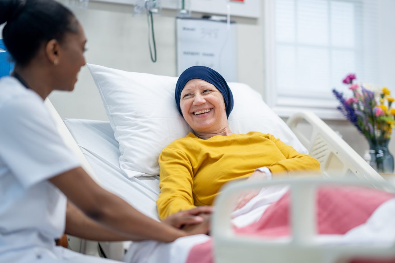 Cancer patient sitting with nurse.