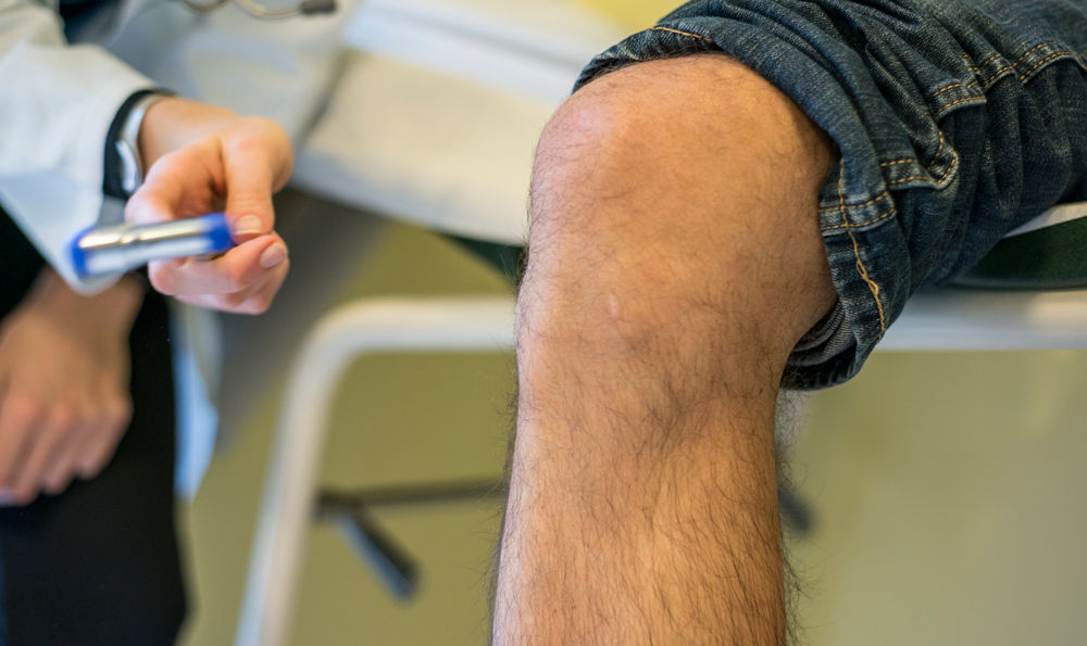A syringe next to a knee
