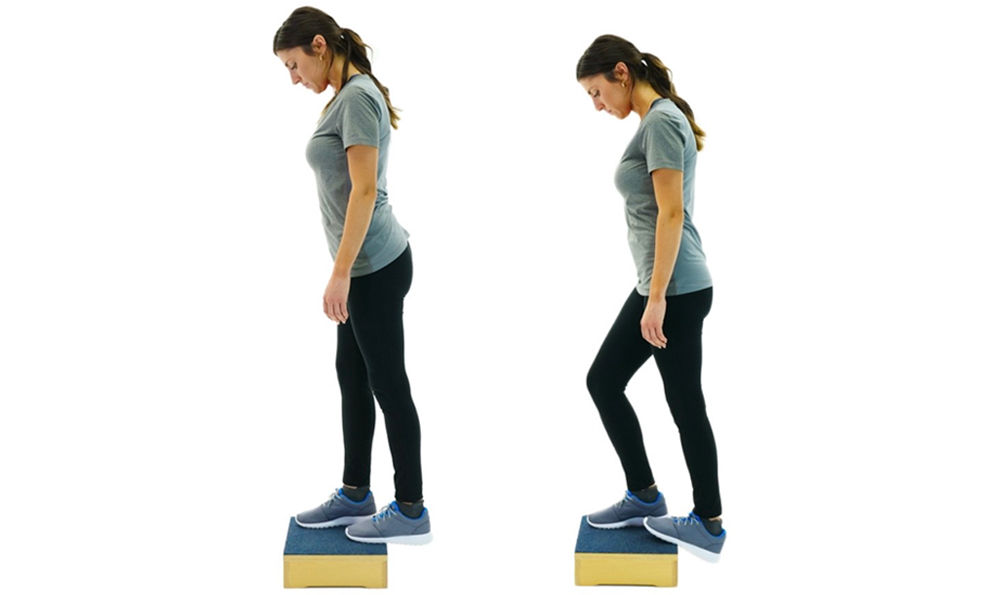 A woman doing plantar fascitis exercises. 