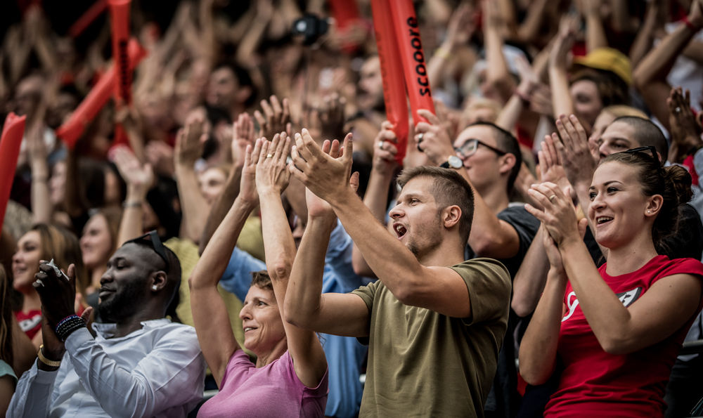 Fans in a crowd cheering.