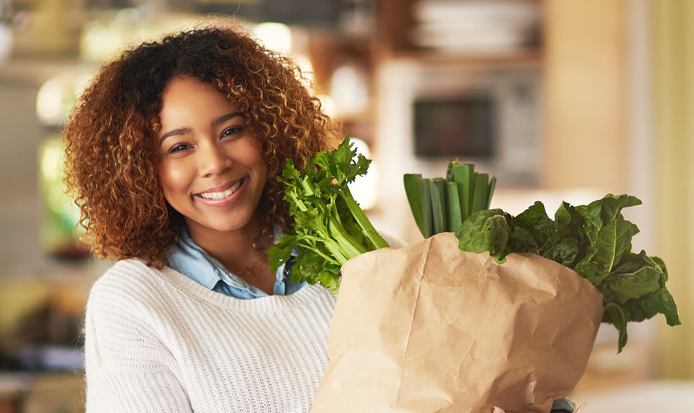 Woman buying vegetables.