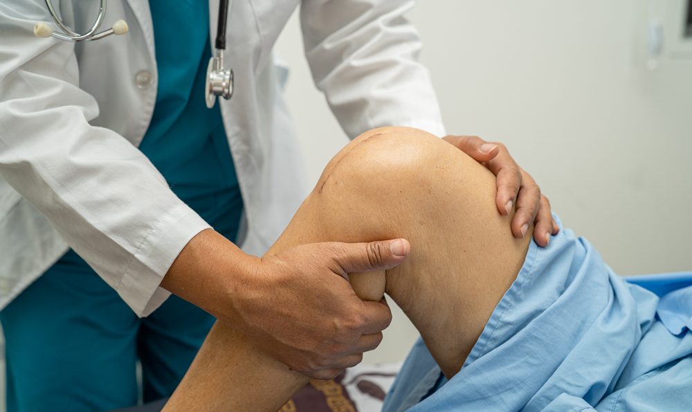 Doctor holding a patient's leg.