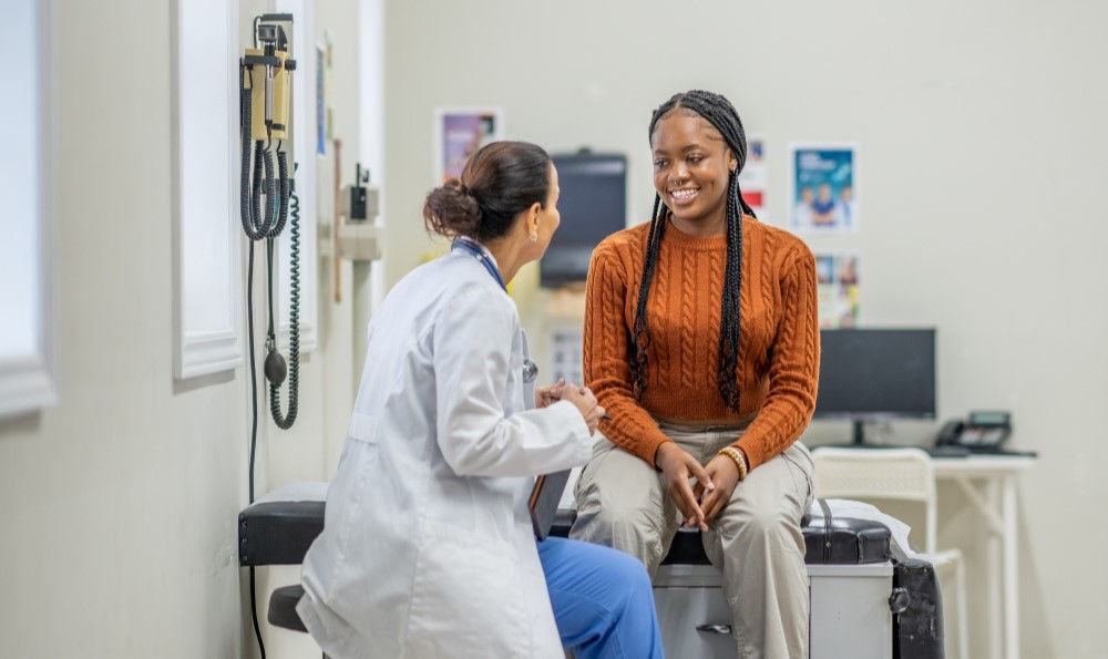 A young woman receiving a health screening. 