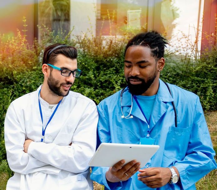 Two physicians conferring with each other.