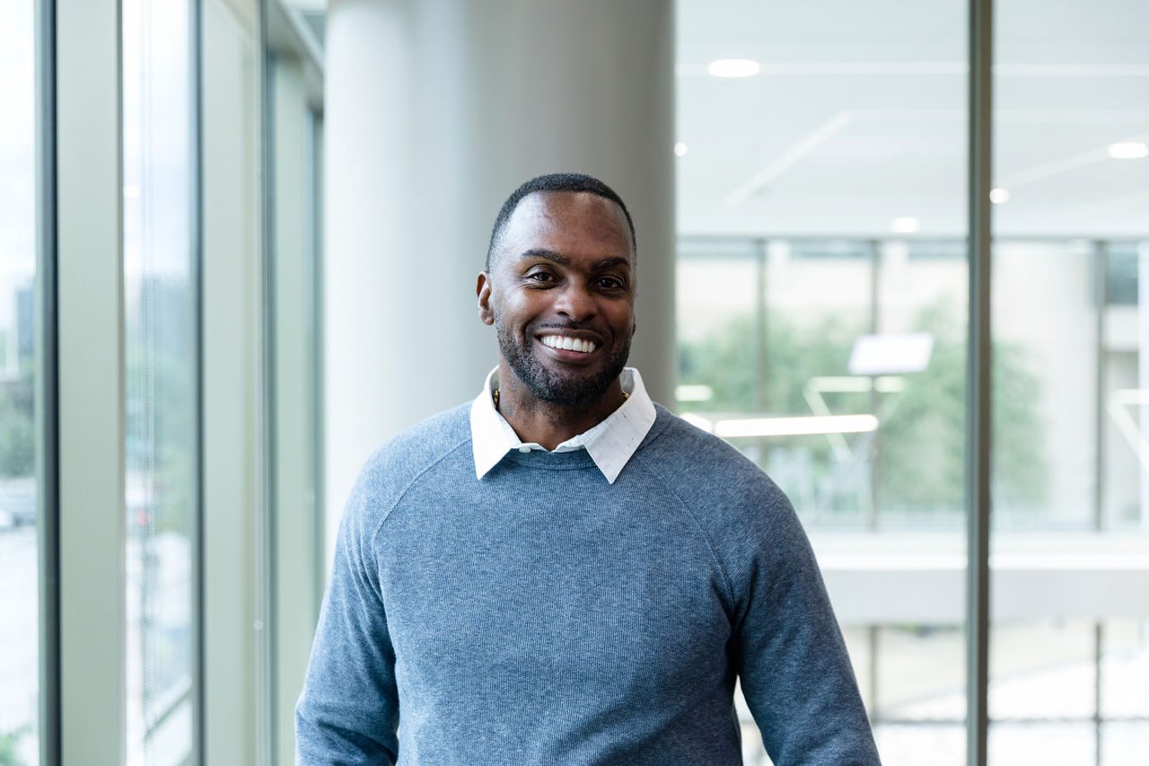 An Administrative Fellow smiling in an office building.