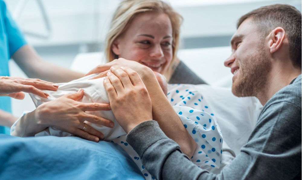 Woman and man seeing their baby after birth.