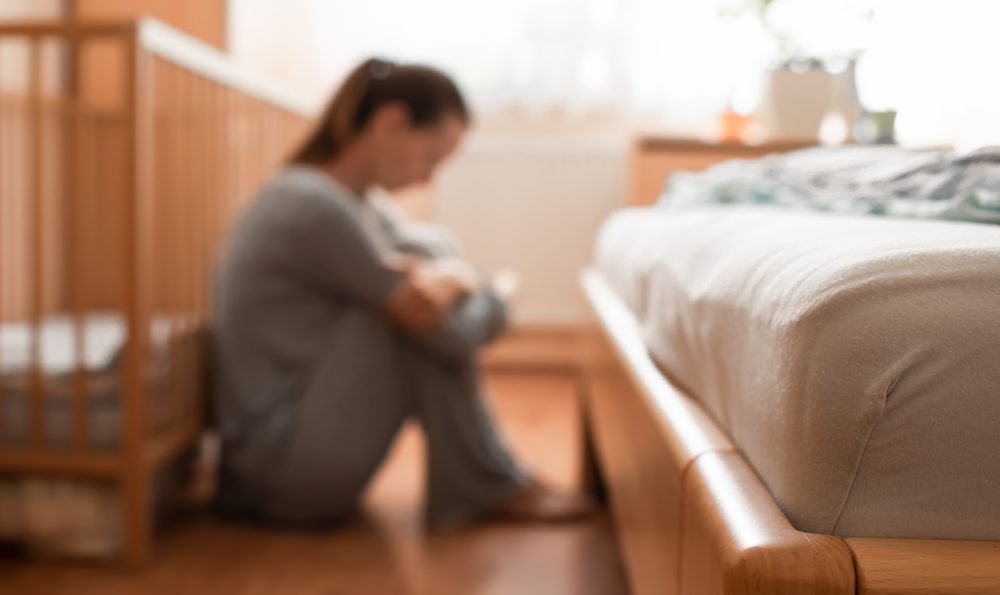 Mother feels overwhelmed in her baby's nursery.