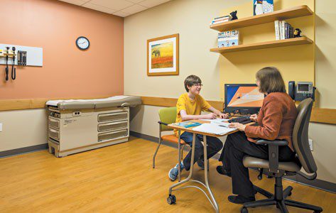 Young patient sitting with counselor 