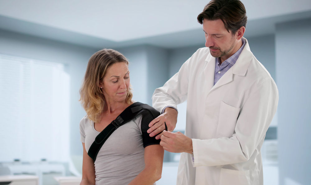 Doctor examining a patient's shoulder.