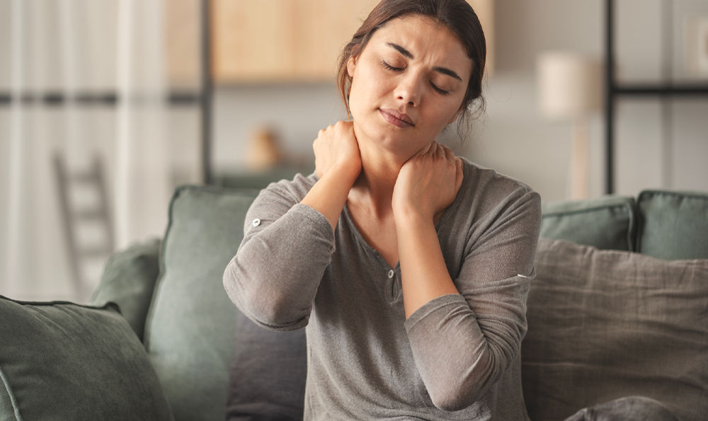 A woman stretching her aching neck.