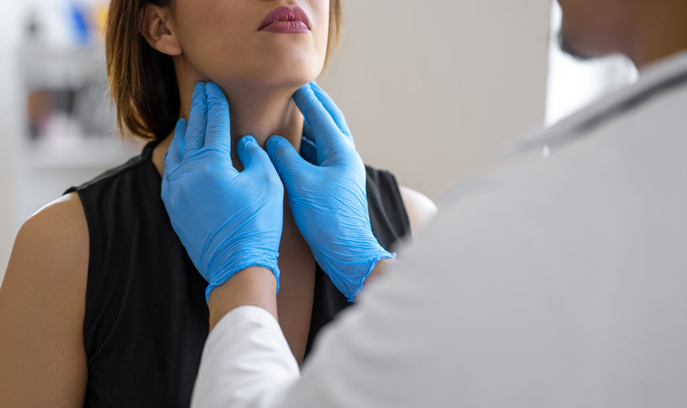 A doctor examining a patient's throat.